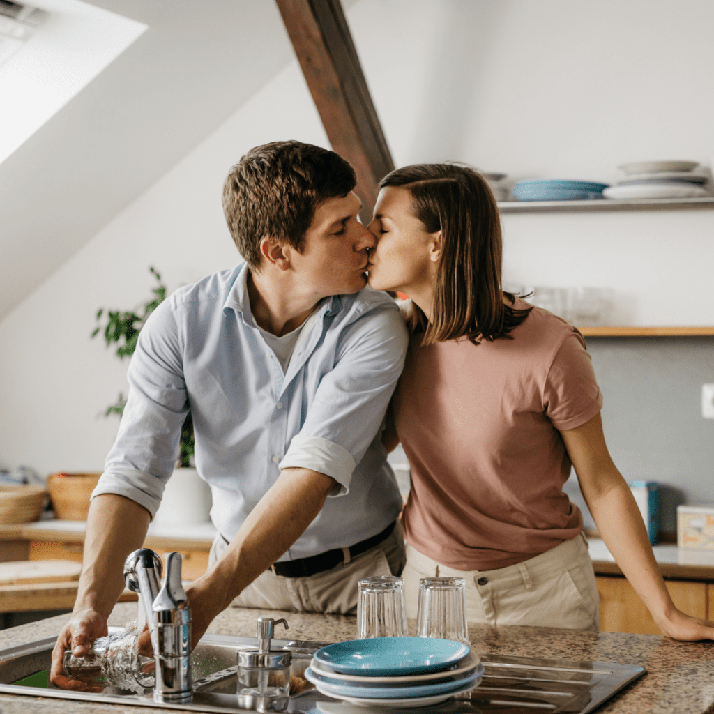 Romantic exchange between couple while doing dishes